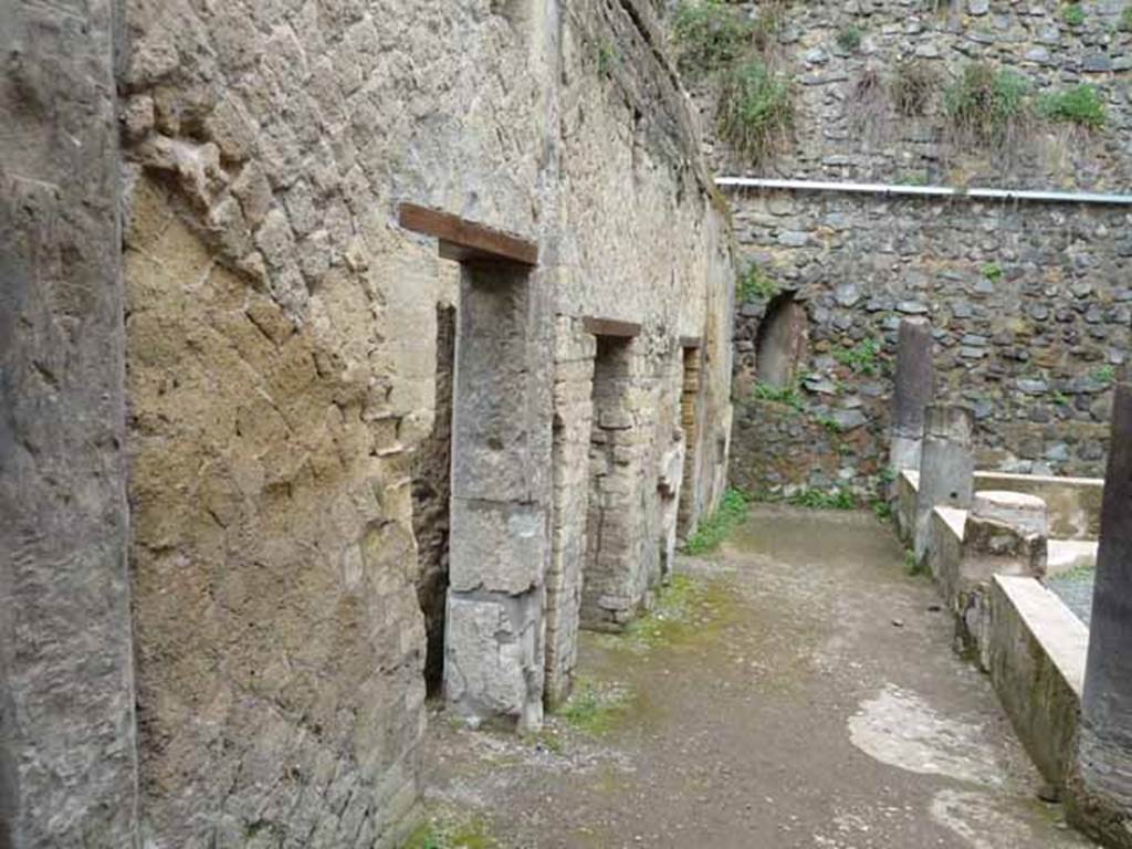 VII.2 Herculaneum. May 2010. Looking west along south wall of peristyle area. 