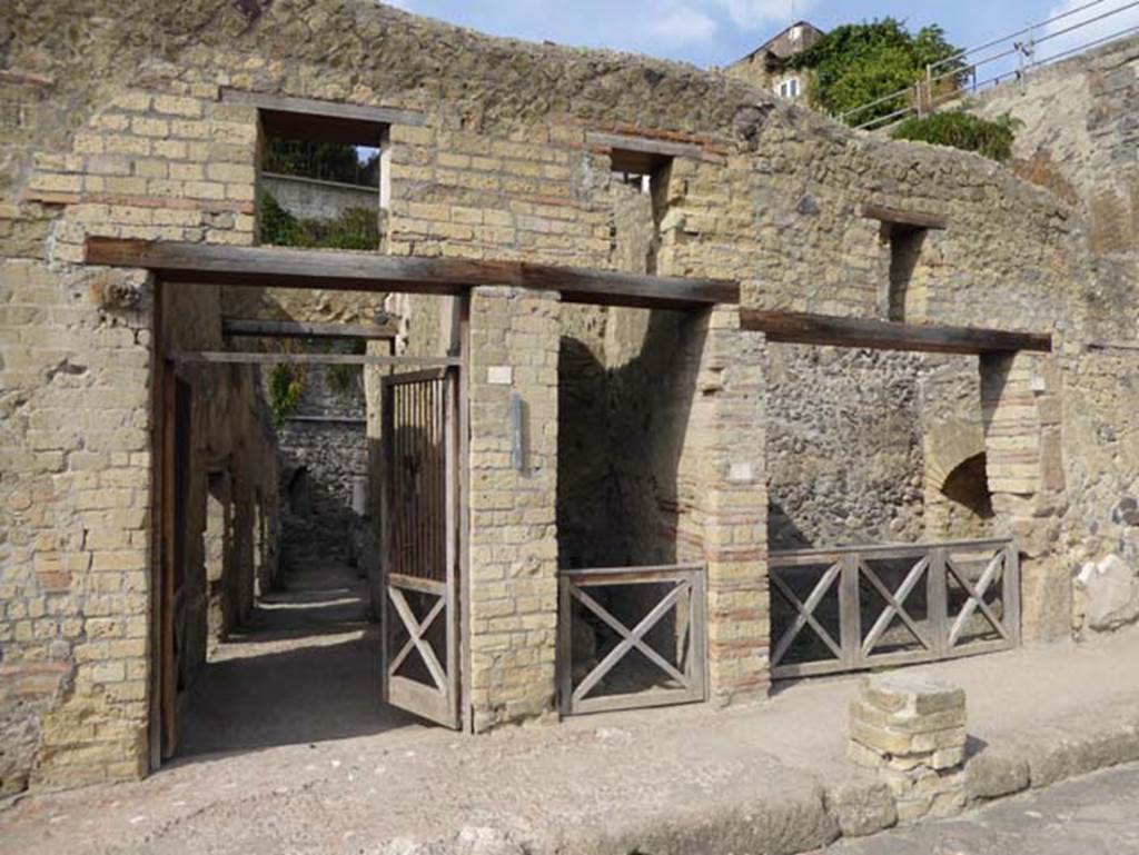 VII, 2, on left, VII.3, in centre, VII.4, on right, Herculaneum. October 2014. Entrance doorways. Photo courtesy of Michael Binns.
