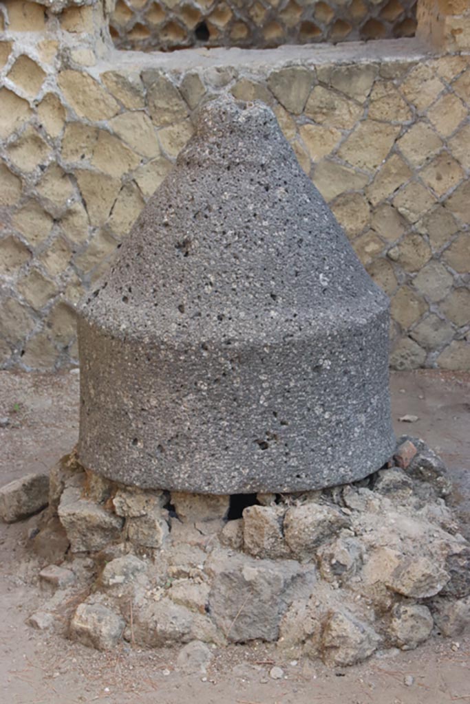 Ins. Or. II, 1a, Herculaneum. October 2023. 
Room A, detail of mill (m’) on west side of bakery. Photo courtesy of Klaus Heese.
