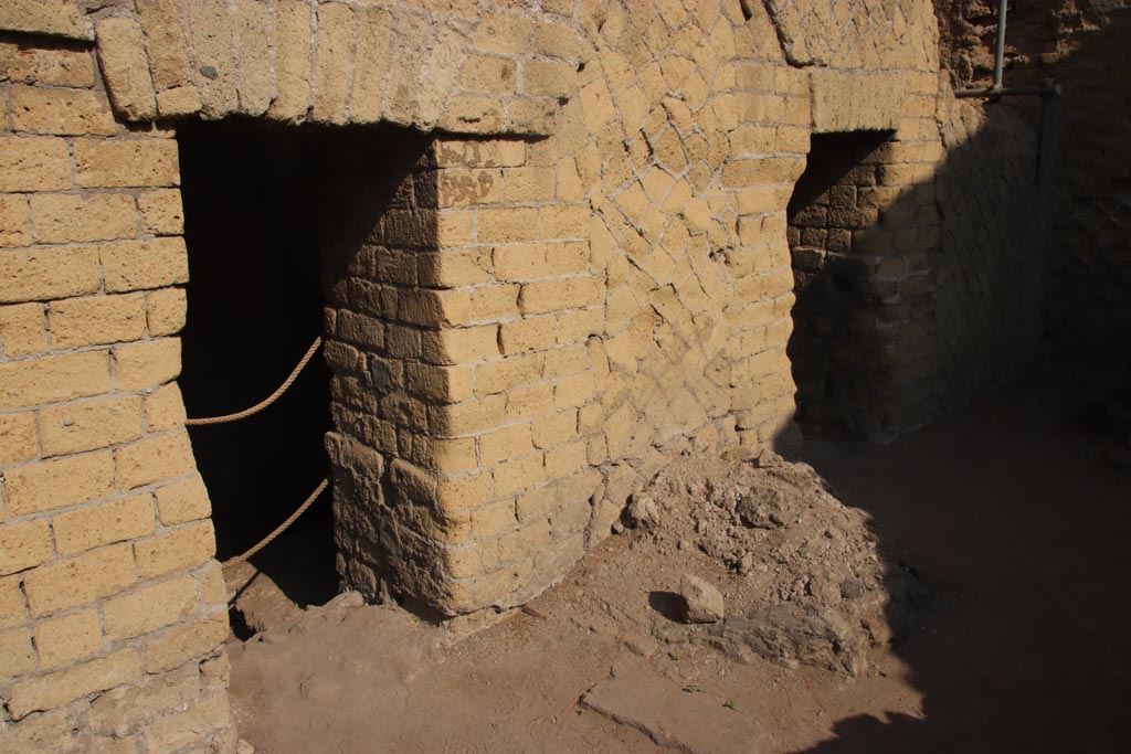 Ins. Or. II, 1a, Herculaneum. October 2023. Room A, two doorways to latrines in west wall of bakery. Photo courtesy of Klaus Heese.