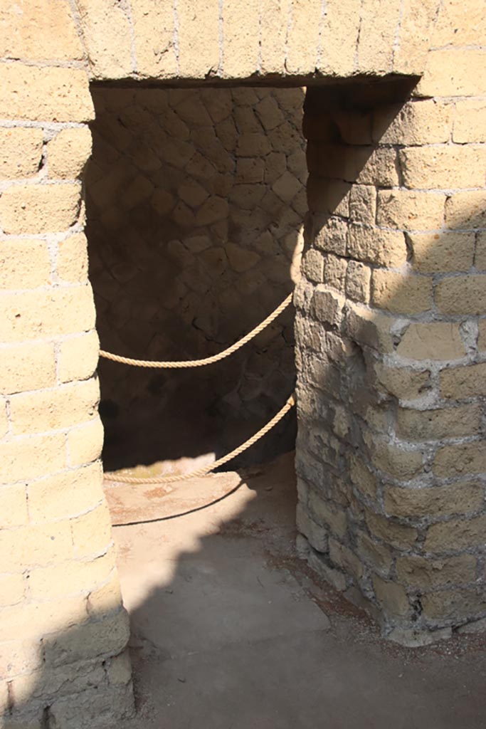 Ins. Or. II, 1a, Herculaneum. October 2023. 
Latrine c’, doorway on west side of bakery, at north end of west wall. Photo courtesy of Klaus Heese.

