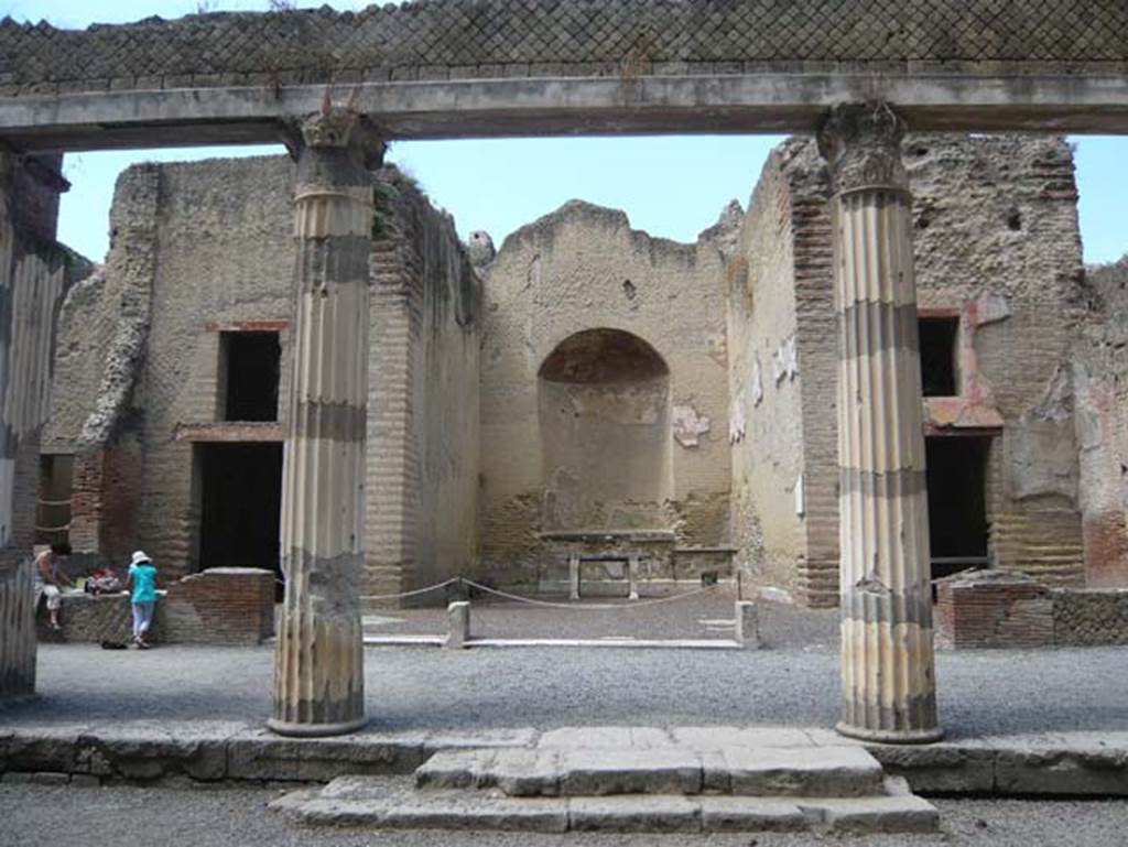 Ins. Orientalis II 4, Herculaneum, August 2013. Looking west from Palaestra towards large apsed room. Photo courtesy of Buzz Ferebee.
This room, according to Deiss, had some forty feet of its height still remaining. 
At the rear was a large niche in which would have stood a statue of an emperor, or even Hercules. In front of the niche was the heavy marble table on which the victor’s olive crowns and other prizes were placed. From this room, the boys and young men would have marched out again, down these steps and out around the arena before the games began.
See Deiss, J.J. (1968). Herculaneum, a city returns to the sun. London, The History Book Club, (p.127)

