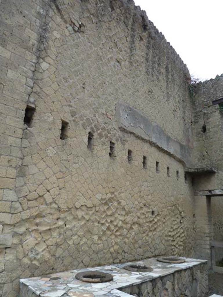 Ins. Orientalis II.6, Herculaneum. September 2015. Looking towards north wall with holes for support beams for an upper floor. On the right, in the north-east corner are the remains of mezzanine floor, as reconstructed by Maiuri.
