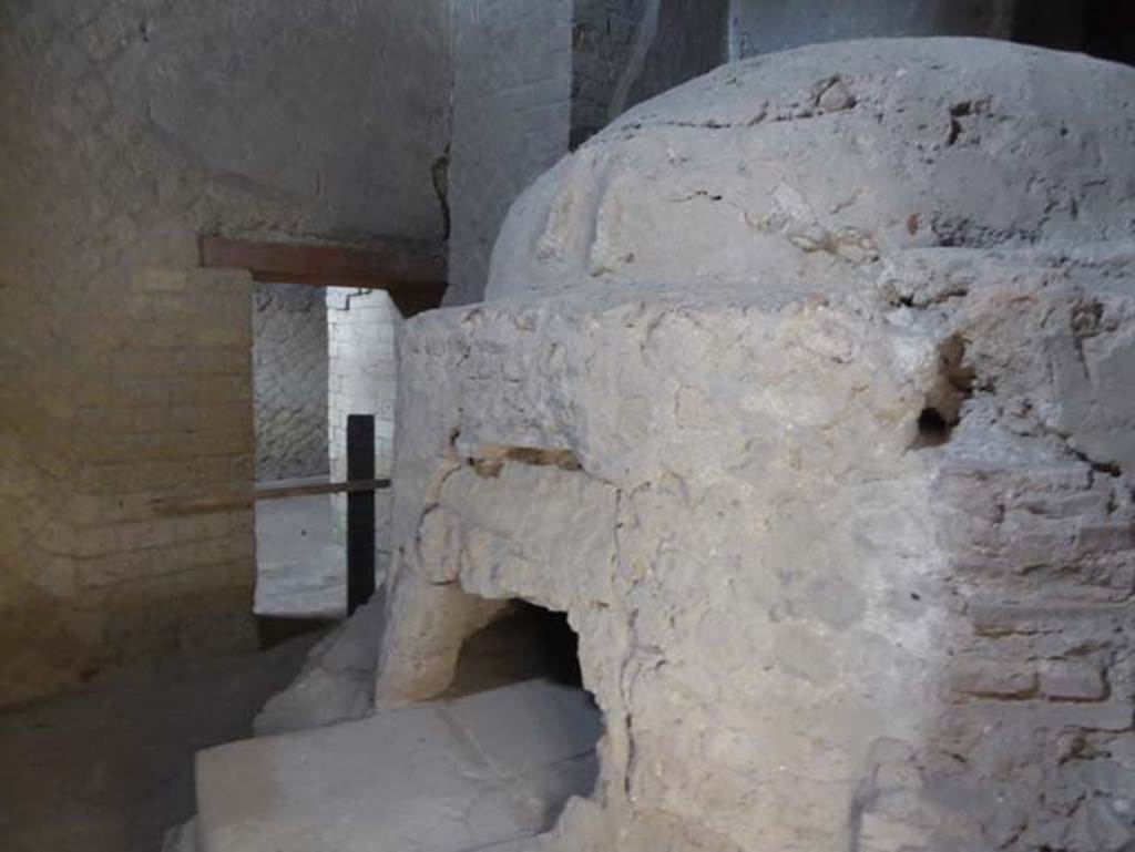 Ins.Or.II.8, Herculaneum, September 2016. Oven with two stucco phalli above doorway. 
Looking north towards other room. Photo courtesy of Michael Binns.


