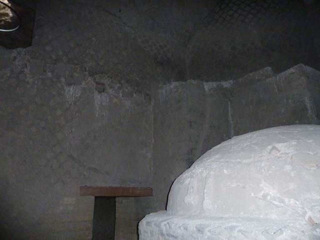 Ins. Orientalis II.8, Herculaneum. September 2015. Looking north towards another doorway into another rear room.
As a double precaution against “the evil eye” the proprietor embedded two stucco phallic emblems above the door of his oven, he also placed another two on the east wall of the next room, in a relief on a terracotta panel.


