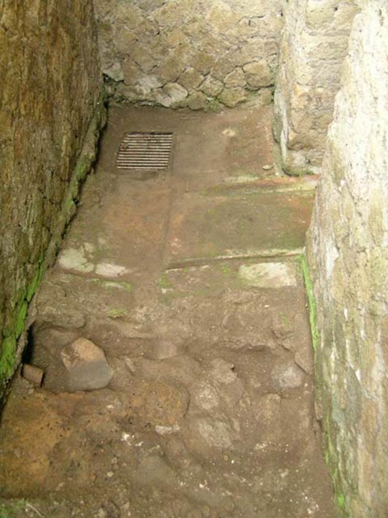 Ins Or II, 8, Herculaneum. December 2004. 
Looking west across Latrine on south side of bakery, under stairs reached by Ins.Or.II.7.  
Photo courtesy of Nicolas Monteix.
