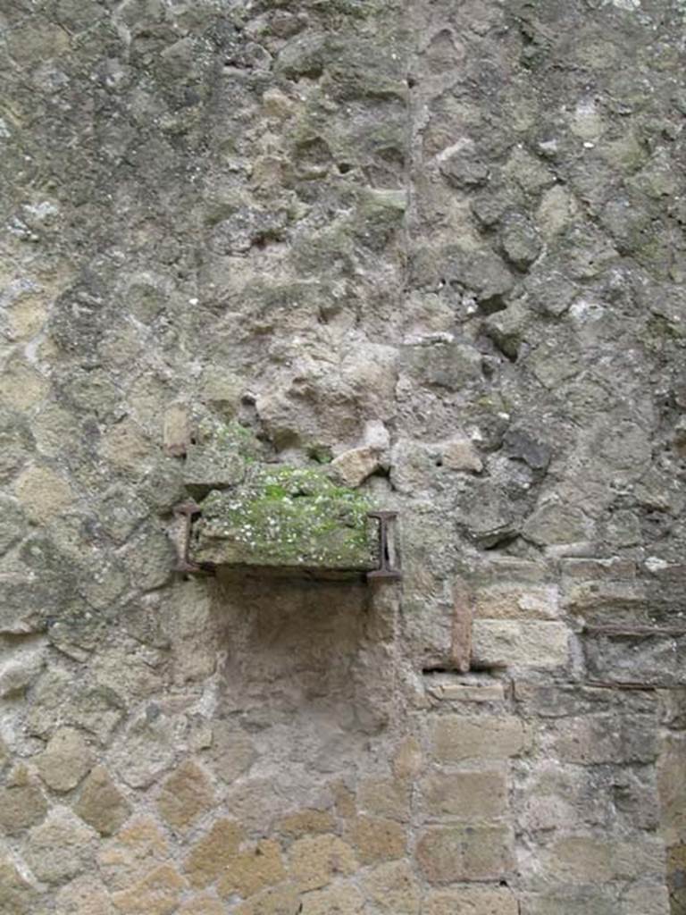 Ins Or II. 13, Herculaneum. December 2004. 
Possible remains of a doorway support sticking out from south wall, just east of doorway to rear side room, behind Ins. Or. II. 12. 
Photo courtesy of Nicolas Monteix.
