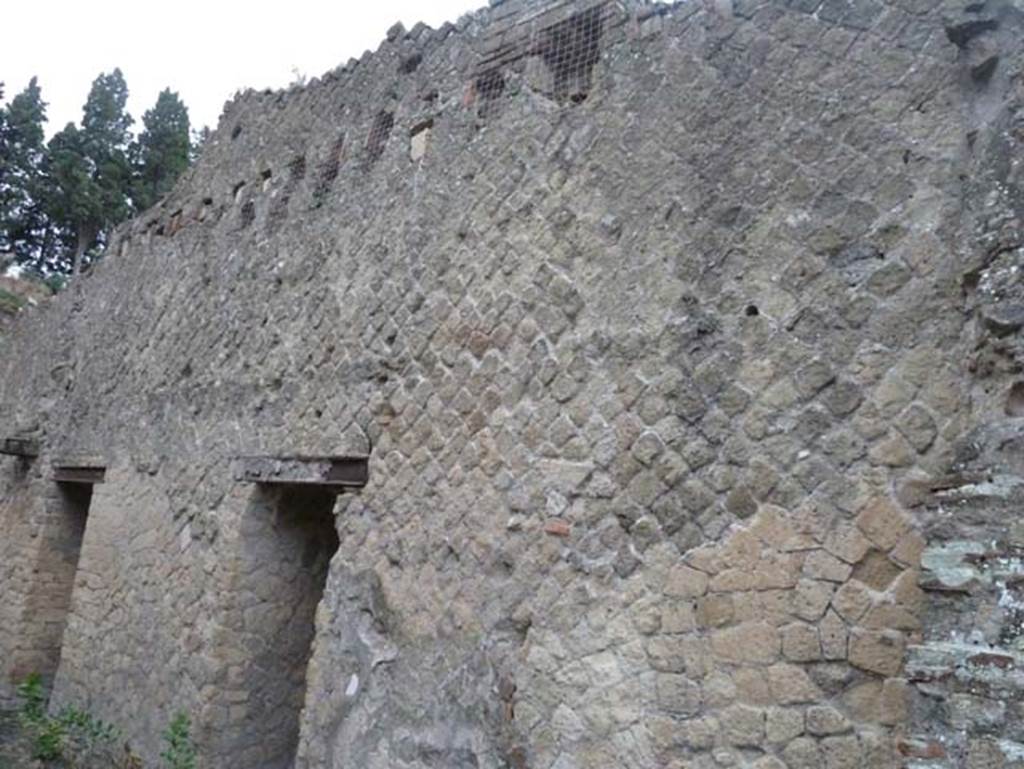 Ins. Orientalis II.13, Herculaneum. September 2015. South wall of shop-room.
Comparing this with the photo below, it would seem the doorway (on the left) leads to other rooms, whereas the “doorway” (centre left) would appear to have been an arched recess originally. 
