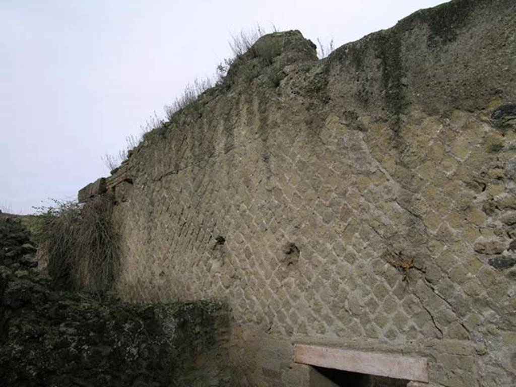 A stone building with a mountain in the background

Description generated with very high confidence