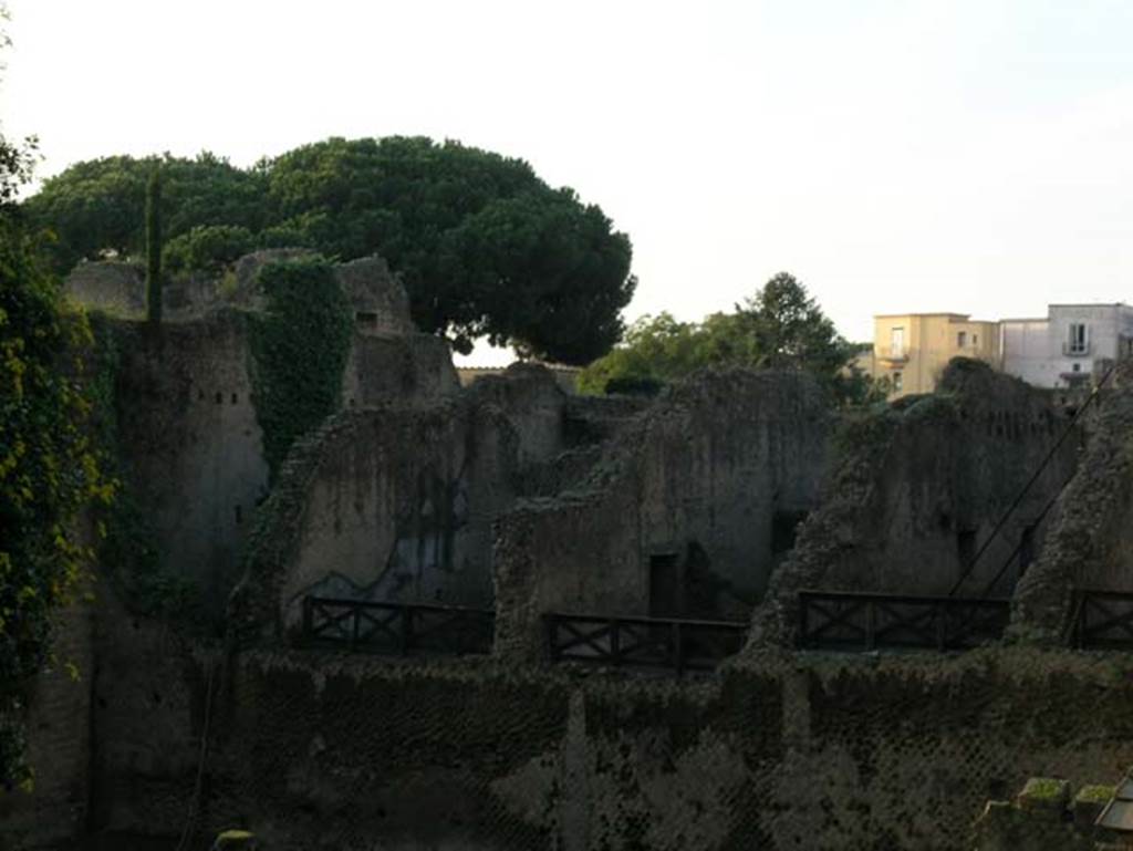 Ins. Orientalis II.13, Herculaneum. December 2004. 
View of Ins. Or.II, 10, 11, 13 (two rooms, the third and fourth room from left), looking west towards rear, across rectangular area on west side of portico. 
Photo courtesy of Nicolas Monteix.
