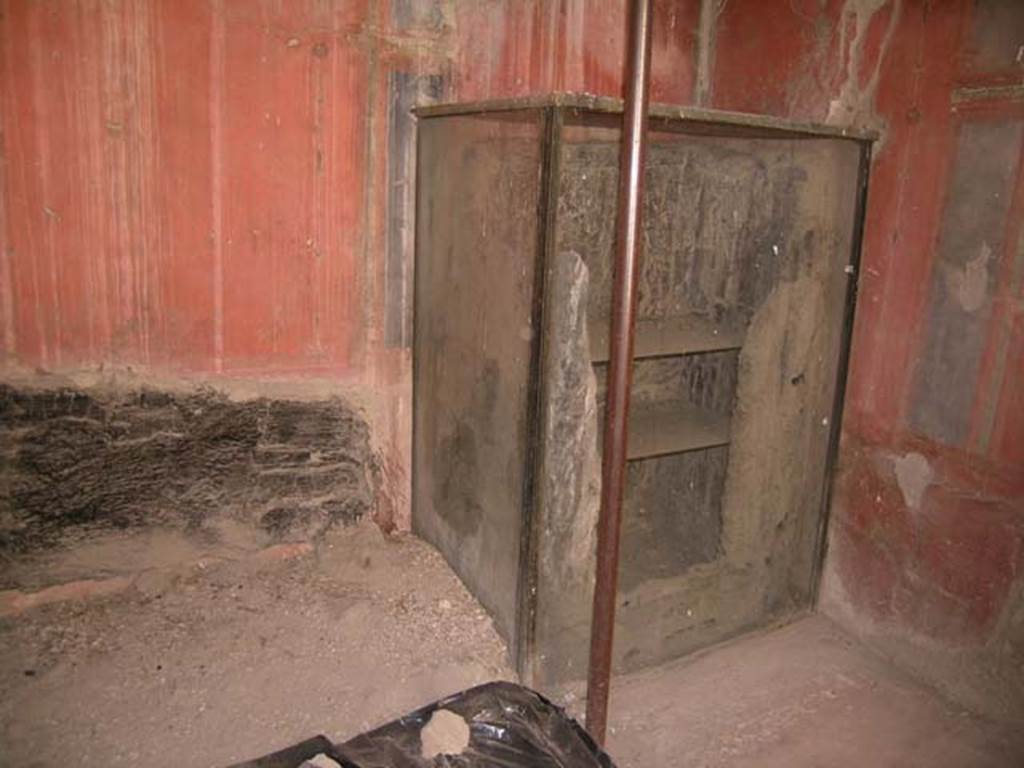 III.14, Herculaneum. April 2005. Room 2, looking towards south wall and south-west corner. Photo courtesy of Nicolas Monteix. Found in this room were two carbonised beds placed at an angle in the corner of the room.
Also found was a cupboard/lararium in which were found bronze statuettes of the domestic cult; two Lares, Jupiter, Minerva, Asclepius, Isis, Fortuna, Harpocrates and a Bacchante. 
