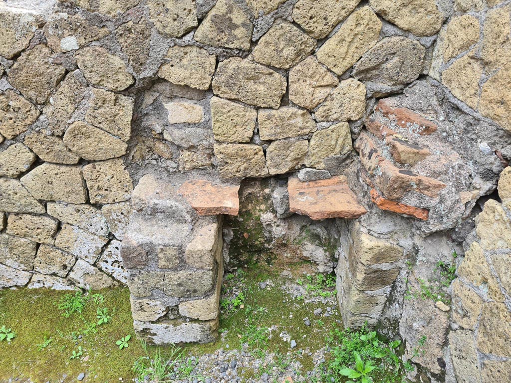 IV.10, Herculaneum. May 2024. 
Looking east towards altar in rear room, with possible arched niche above. Photo courtesy of Klaus Heese.
