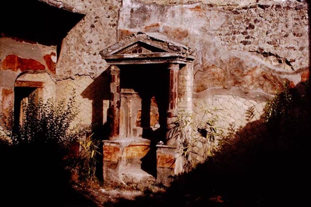 V.5 Herculaneum. 1964. Garden room 9. Looking towards east wall with aedicula shrine.  Photo by Stanley A. Jashemski.
Source: The Wilhelmina and Stanley A. Jashemski archive in the University of Maryland Library, Special Collections (See collection page) and made available under the Creative Commons Attribution-Non-Commercial License v.4. See Licence and use details.
J64f1181
According to Jashemski, the little courtyard at the rear of the house had an elaborate aedicula shrine visible from the entrance corridor.
There were the remains of an animal painting on the east wall.
See Jashemski, W. F., 1993. The Gardens of Pompeii, Volume II: Appendices. New York: Caratzas. (p.267-8)
