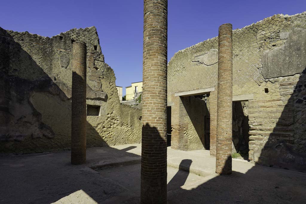 VI.29 Herculaneum. August 2021. 
Looking south-west across impluvium in atrium 3, towards south wall with niche/recess. Photo courtesy of Robert Hanson.
