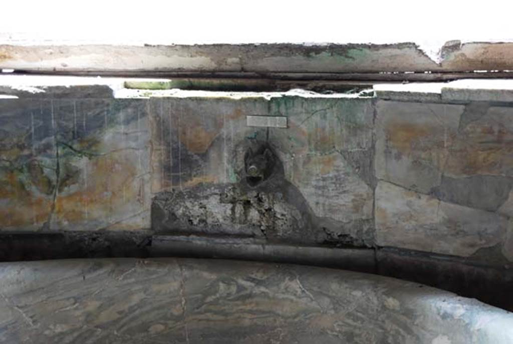 Suburban Baths, Herculaneum. April 2008. Looking south to ornamental water inlet on rear wall behind marble basin.
Photo courtesy of Nicolas Monteix.
