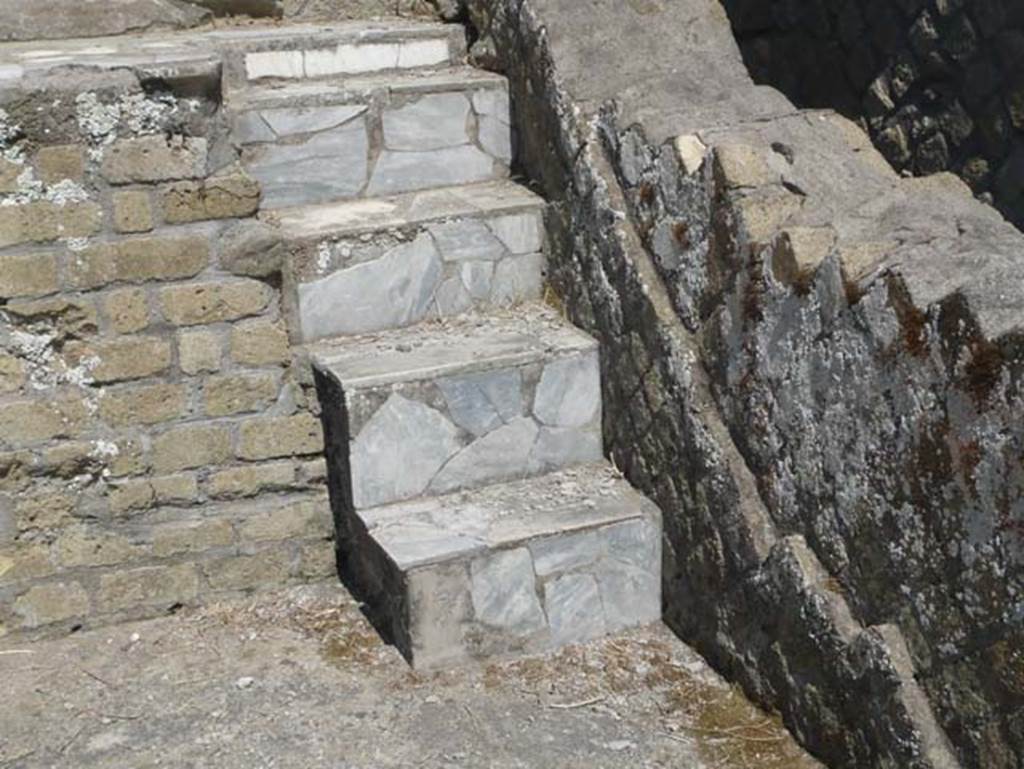 Herculaneum, August 2013. Sacred Area terrace, detail of steps on east end of the shrine of the Four Gods. Photo courtesy of Buzz Ferebee.
