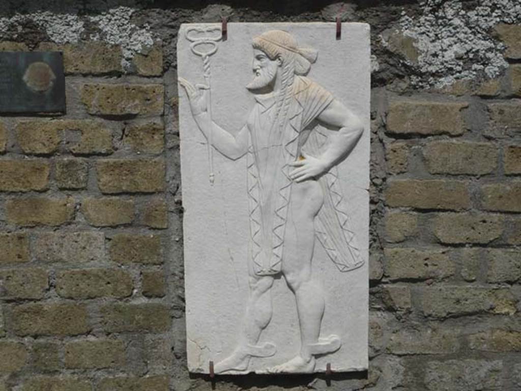 Herculaneum, August 2013. Sacred Area terrace, the shrine of Four Gods. Reproduction relief of Mercury. Photo courtesy of Buzz Ferebee. 
