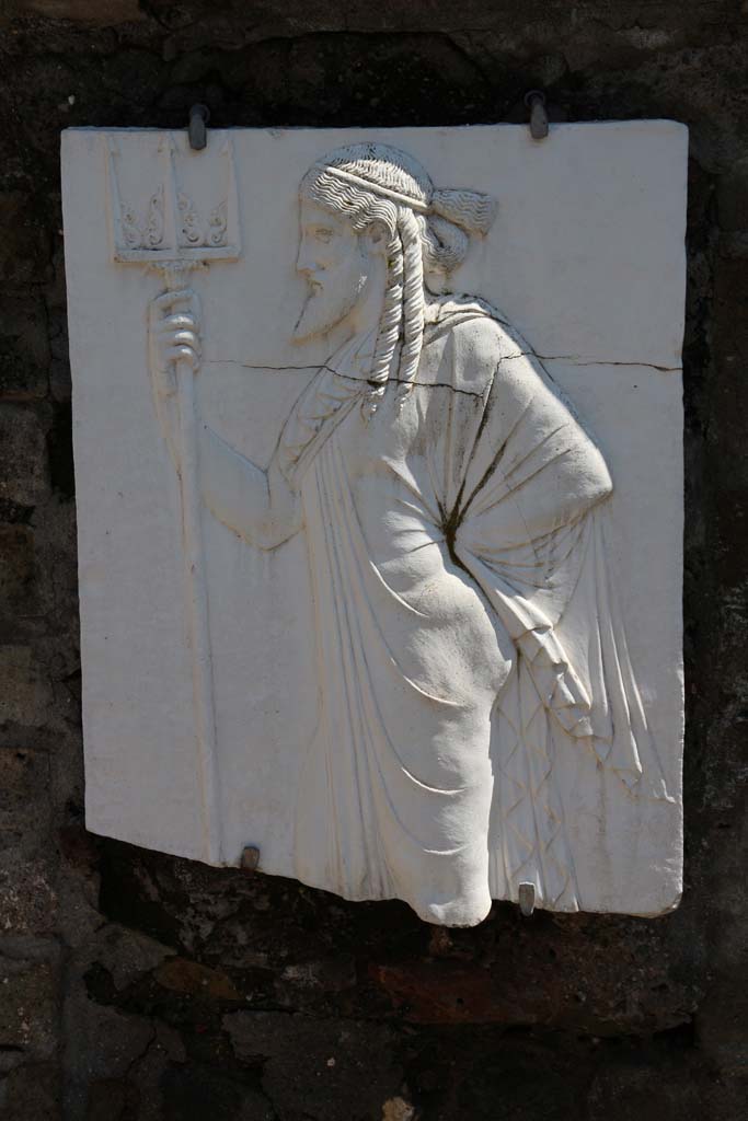 Herculaneum, April 2014. Sacred Area terrace, the shrine of Four Gods. Reproduction relief of Neptune. 
Photo courtesy of Klaus Heese.
