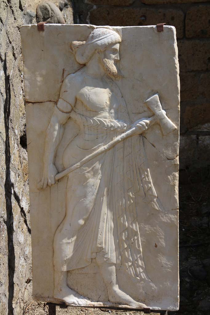 Herculaneum, April 2014. 
Sacred Area terrace, the shrine of Four Gods. Reproduction relief of Vulcan. 
Photo courtesy of Klaus Heese.
