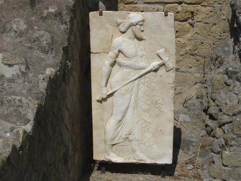 Herculaneum, August 2013. Sacred Area terrace, the shrine of Four Gods. Reproduction relief of Vulcan. Photo courtesy of Buzz Ferebee. 
