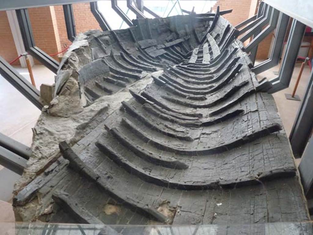 Beachfront, Herculaneum, June 2012. Boat found on 3rd August 1982 on the ancient beachfront.
The boat is about 10 metres in length and is now on display in its own Boat Exhibit, with other artefacts.
Photo courtesy of Michael Binns.
