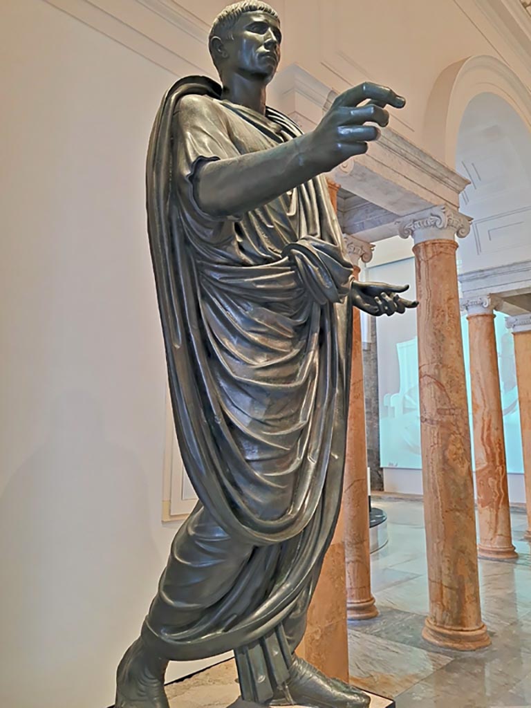 Herculaneum theatre. April 2023. Detail of bronze statue of Lucius Mammius Maximus. 
On display in “Campania Romana” gallery in Naples Archaeological Museum, inv. 5591.
Photo courtesy of Giuseppe Ciaramella.

