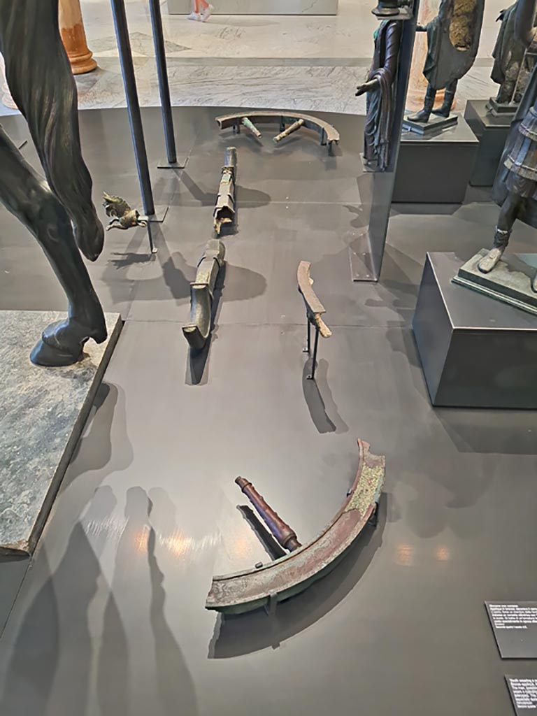 Herculaneum, April 2023. 
Detail of bronze chariot wheels and parts in “Campania Romana” gallery in Naples Archaeological Museum. Photo courtesy of Giuseppe Ciaramella.

