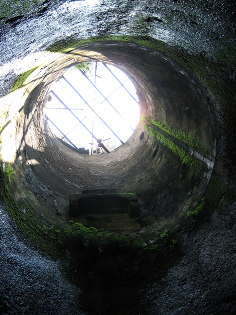 Herculaneum Theatre, July 2009. 
The eighteenth-century access shaft to the theatre. Photo courtesy of Sera Baker.

“From the lower vestibule a flight of 72 steps cut into the tufa bank leads down to the upper part of the theatre (summa cavea), recognizable from the double flights of steps that descend to the great circular ambulacrum between the summa and the media cavea; the latter is traversable from one extremity to the other, where there are stairs leading down to the level of the orchestra”…….
See Maiuri, A, (1977). Herculaneum, (p.73)
