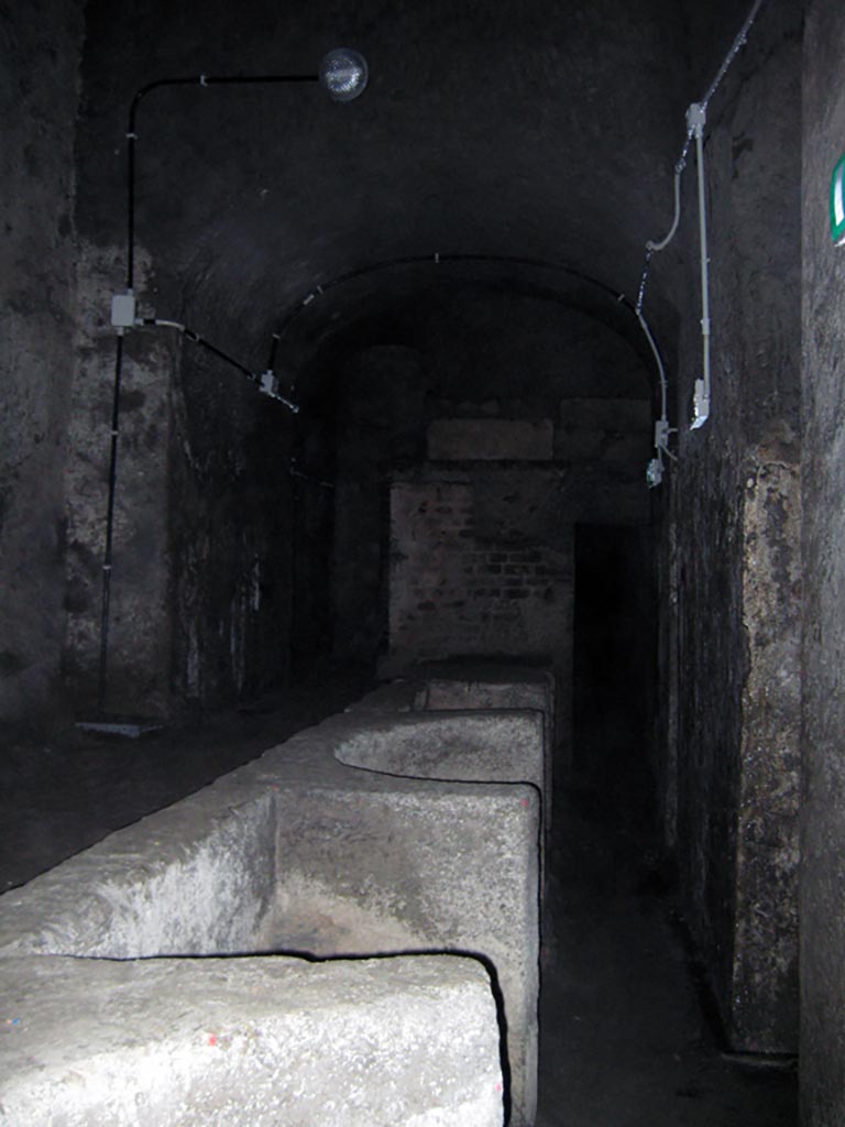 Herculaneum Theatre, July 2009. Proscenium and Pulpitum. Photo courtesy of Sera Baker.
“Upon ascending one of the little side-stairs which connect the orchestra with the pulpitum, there are still to be glimpsed the skeletal remains of the mural structure of what was once the magnificent architectonic façade of the scene (scaena).”
See Maiuri, p.74
(Definition of pulpitum, the stage for actors.)
