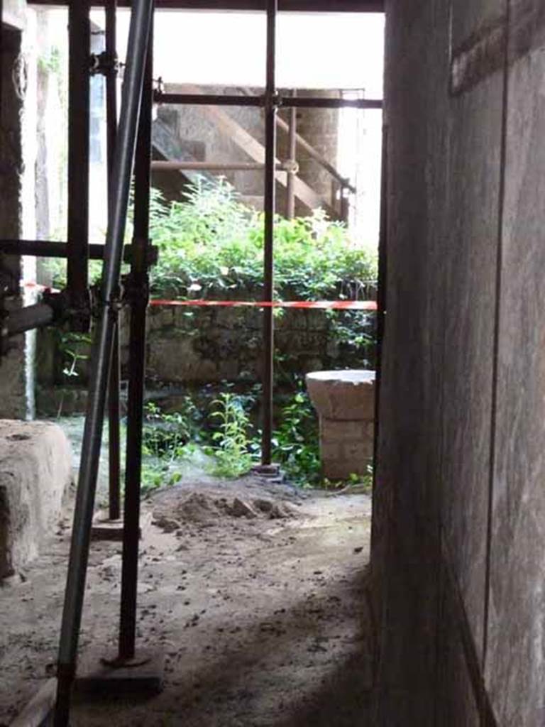 Ins. III. 14, May 2010. Looking west towards small courtyard. According to Jashemski, this paved courtyard gave light to the various rooms in this dwelling. The courtyard was enclosed with a small low wall to form a basin to collect rain water.
See Jashemski, W. F., 1993. The Gardens of Pompeii, Volume II: Appendices. New York: Caratzas. (p.260)
