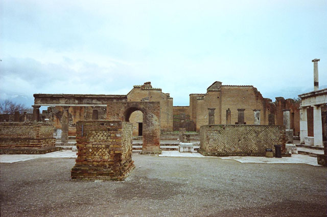 Arched monument at south end of Forum. About 1829. Looking down from above the Forum and across the bay to Sorrento. The remains of the arched monument and the others for the Imperial family are at the centre of the drawing. See Mazois, F., 1829. Les Ruines de Pompei: Troisieme Partie. Paris: Didot Freres. Plate XXIX.