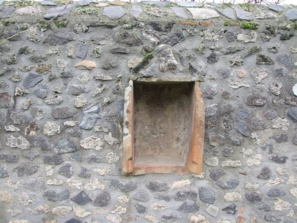 I.11.12 Pompeii.  December 2006.  Aedicula Niche on South wall of Garden.  A Venus statuette was found in the niche. Small cavities had been made in the wall on both sides of the niche. The heads of 3 small herms were found in three of them.