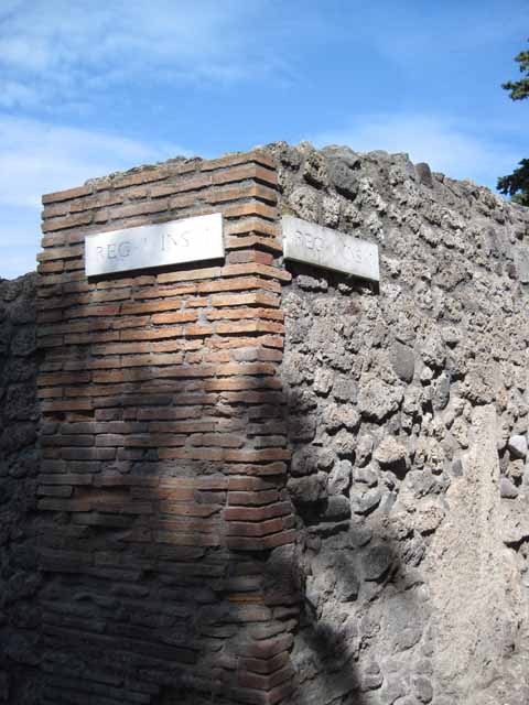 I.1.10 Pompeii. September 2010. Looking east along unnamed vicolo between regio I and city walls. The entrance doorway to I.1.10 is in the left wall. Photo courtesy of Drew Baker.