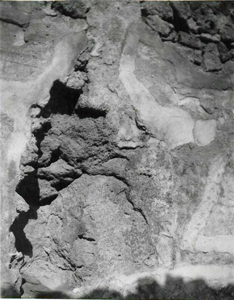 I.2.3 Pompeii. 1935 photo taken by Tatiana Warscher. Warscher described this photo as a part of the north wall of triclinium “d”. Describing from Fiorelli, Descrizione, p.37, she quoted: “I.2.3 “Di fronte all’ingresso si trovano il tablino (e) ed il triclinio (d), in cui è notevole un grande masso di lava vesuviana dell’età preistorica, a cui fu addossato uno dei muri (nord) di questa stanza, e che prolungasi internamente sotto le fondazioni delle camere adiacenti”.
See Warscher T., 1935. Codex Topographicus Pompeianus: Regio I.2. (no.9), Rome: DAIR, whose copyright it remains.   
(translation: "I. 2.3" facing the entrance you will find the tablinum (e) and the triclinium (d), in which it was noted there was a large boulder of vesuvian lava of prehistoric age, which was leaning against one of the walls (north wall) of this room, and that it extended internally under the foundations of the adjacent rooms”.)