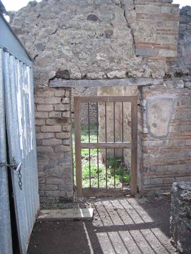 I.2.18 Pompeii. September 2010. Looking west from rear of bar counter, towards doorway to peristyle garden of I.2.17. Photo courtesy of Drew Baker.
