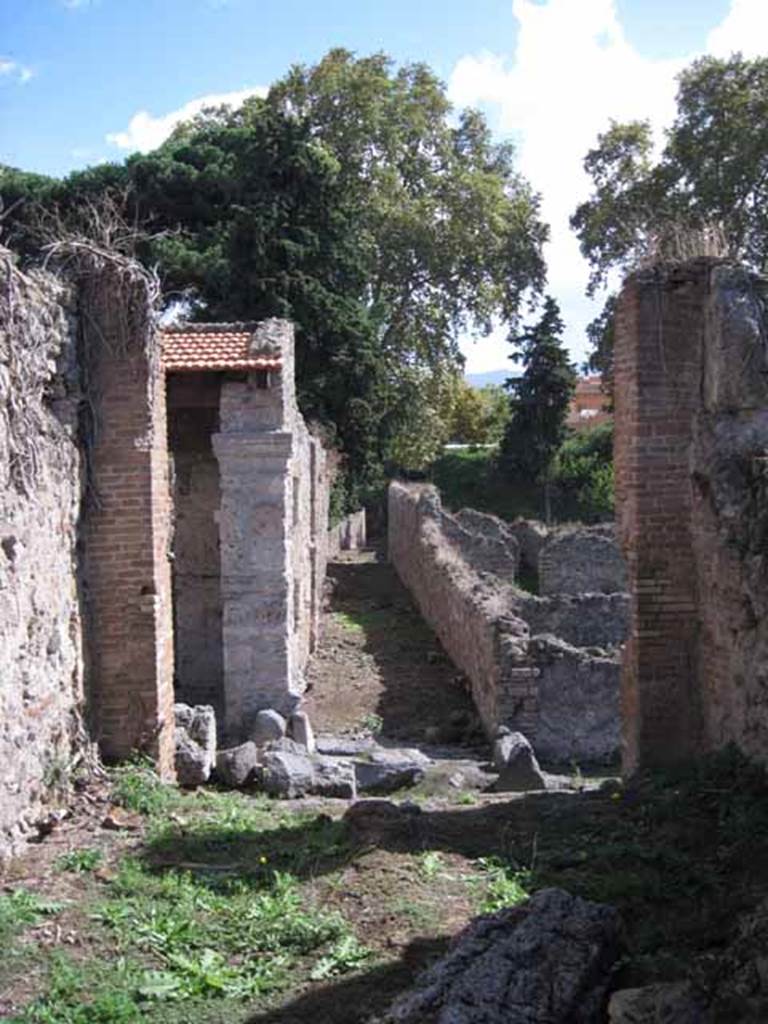 I.2.29 Pompeii. September 2010. Looking south from rear of bar-room, towards Vicolo del Conciapelle. The unnamed vicolo between I.1 and I.5 can be seen directly across the roadway. Photo courtesy of Drew Baker.
