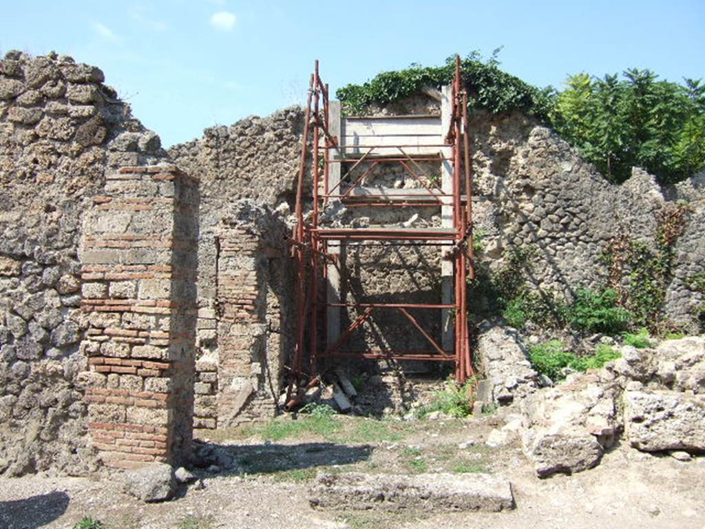 I.2.31 Pompeii. September 2010. Looking north from southern rear room towards the second rear room. A wall with a doorway leading from one to the other would have been across the photo at the front of the scaffolding.
Photo courtesy of Drew Baker.
