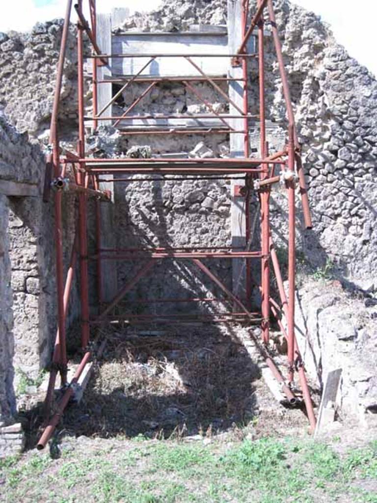 I.2.31 Pompeii. September 2010. West wall, with two doorways leading from two separate rear rooms into the main bar-room. Photo courtesy of Drew Baker.
