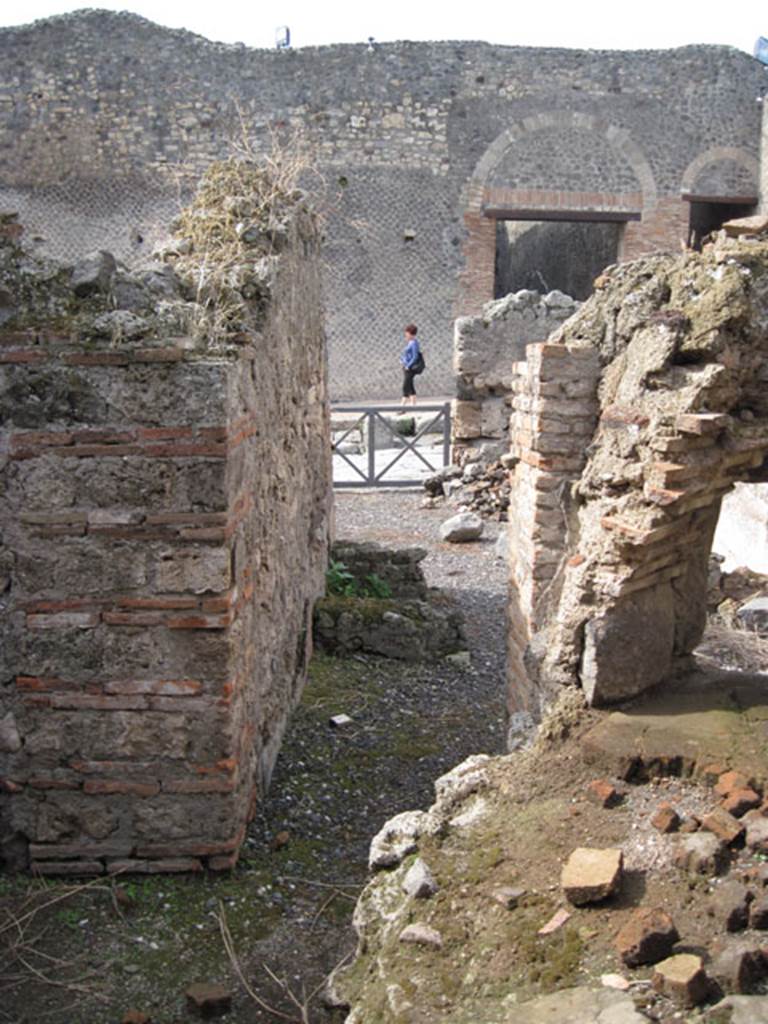 I.3.1 Pompeii. September 2010. Looking west through doorway towards bakery room and Via Stabiana, from rear room on south side of oven. Photo courtesy of Drew Baker.

