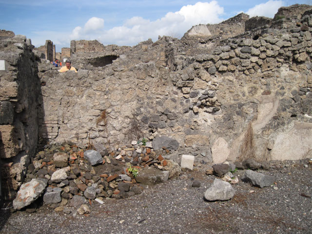 I.3.1 Pompeii. September 2010. West wall and doorway of small room, looking towards entrance from Via Stabiana, and west wall of bakery room. Photo courtesy of Drew Baker.
