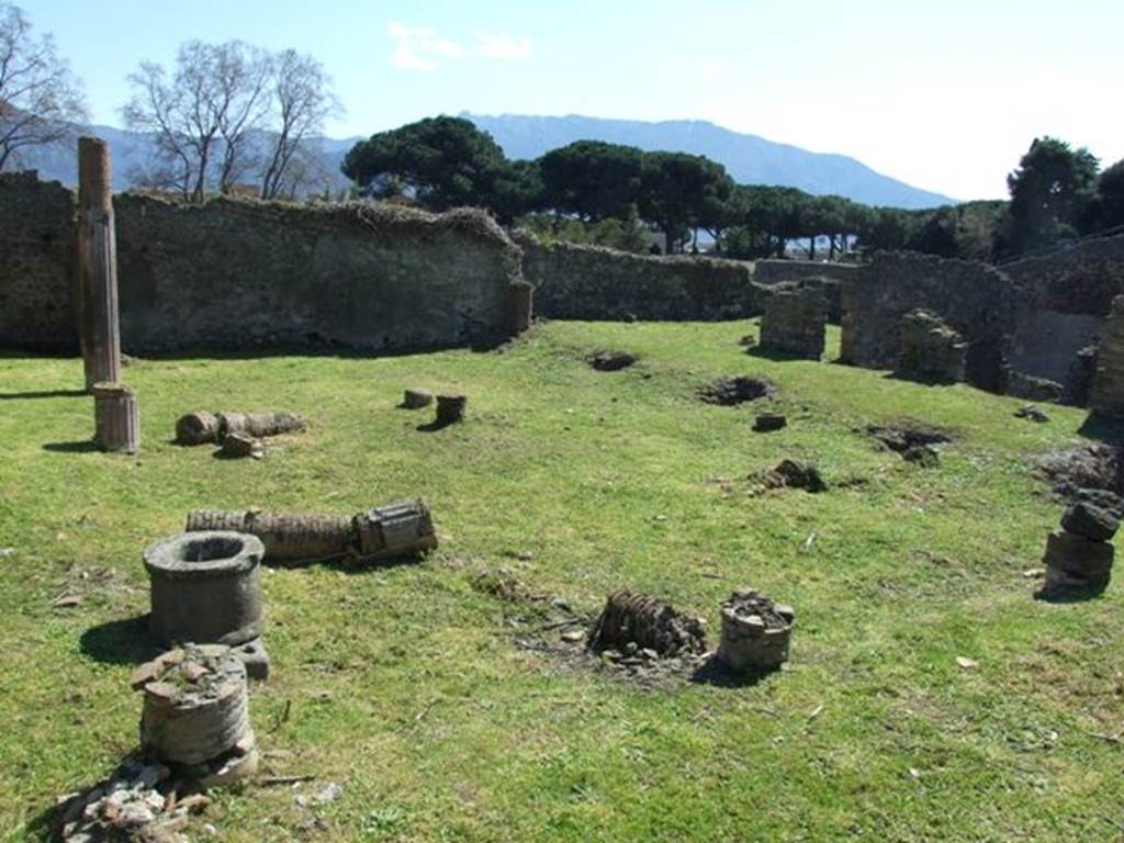 1.3.3 Pompeii. March 2009. Upper peristyle area, looking south-west across garden area from north-east corner. A tufa puteal, and remains of brick columns covered in stucco and painted red can be seen. According to Jashemski, the garden was enclosed on the west, north and east sides by a portico. The portico was supported by 10 columns and 2 engaged columns leaning against the south wall. The columns were made of brick and covered with stucco painted red.  There was a gutter around the edges of the garden on the west, north and east.  According to Mau, there were 2 cistern openings, one in the north-east corner of the garden, with a tufa puteal, the other opening in the corresponding corner of the portico.   See Jashemski, W. F., 1993. The Gardens of Pompeii, Volume II: Appendices. New York: Caratzas. (p.26)

