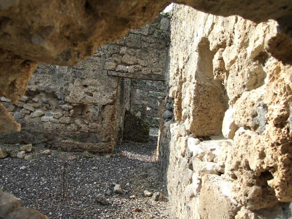 I.3.8b Pompeii. December 2006. Looking west across kitchen on east side, through hole in wall from I.3.25