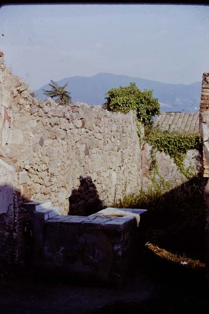 I.3.22 Pompeii. December 2007. West wall. At the front, on the right, are the remains of the staircase at I.3.21 which led to the upper storey of I.3.22. At the rear, on the left, is a doorway linking to I.3.20.