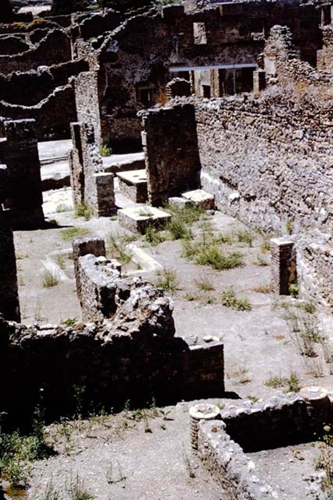 I.4.2 Pompeii. 1966. Looking from top of stairs across south portico to tablinum and atrium. 
The doorway from I.4.3 can be seen on the north (right) side of the entrance doorway of I.4.2. Photo by Stanley A. Jashemski.
Source: The Wilhelmina and Stanley A. Jashemski archive in the University of Maryland Library, Special Collections (See collection page) and made available under the Creative Commons Attribution-Non Commercial License v.4. See Licence and use details.
J66f0151
