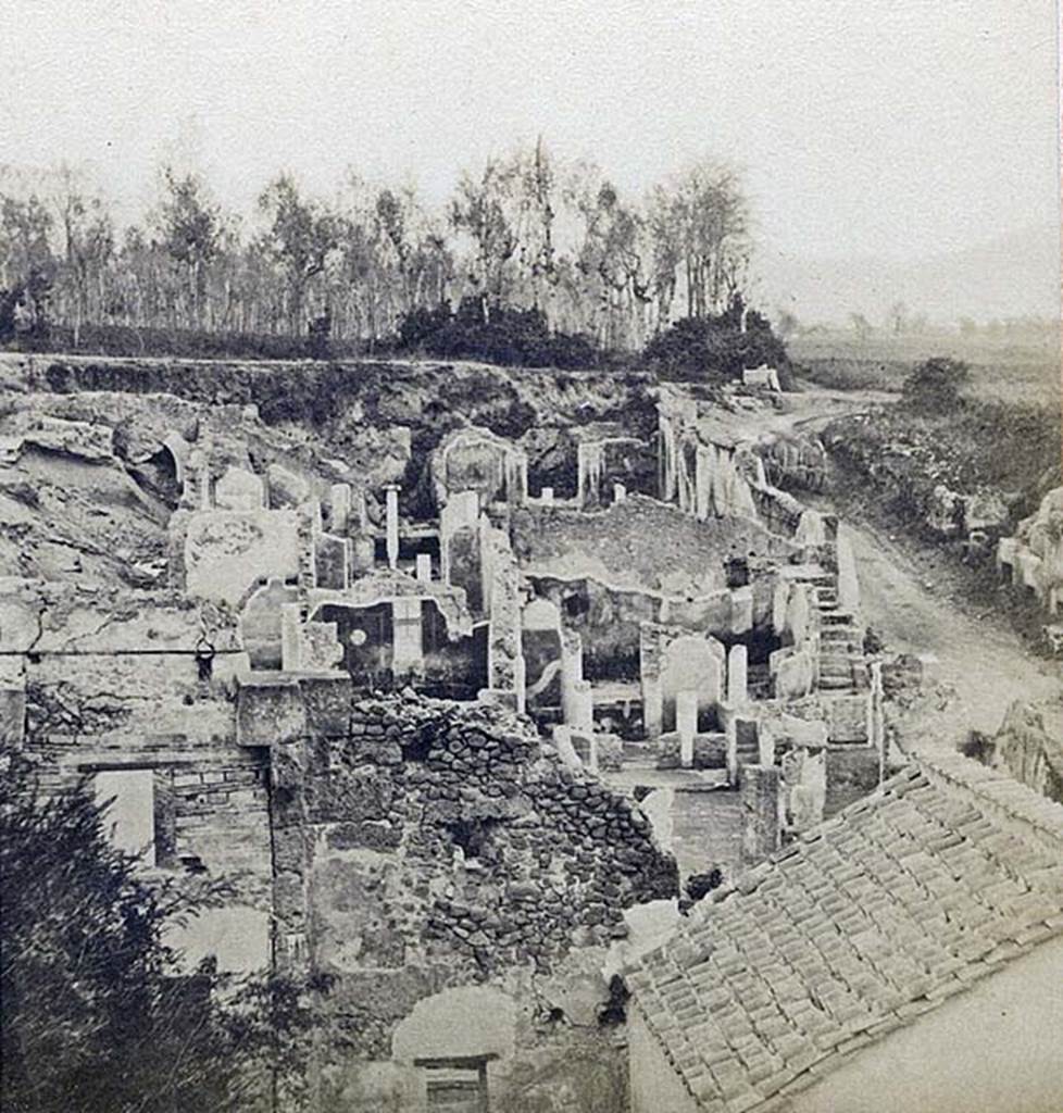 I.4.2 Pompeii. Detail from stereoview by R. Rive, c.1860-1870s.
Looking across atrium towards peristyle at rear, and steps in south-east corner (all above the rebuilt roof in the right hand lower corner of the picture). 
At the rear of the east wall of the peristyle would be the lower (third) peristyle of 1.4.5/25.
Photo courtesy of Rick Bauer.
