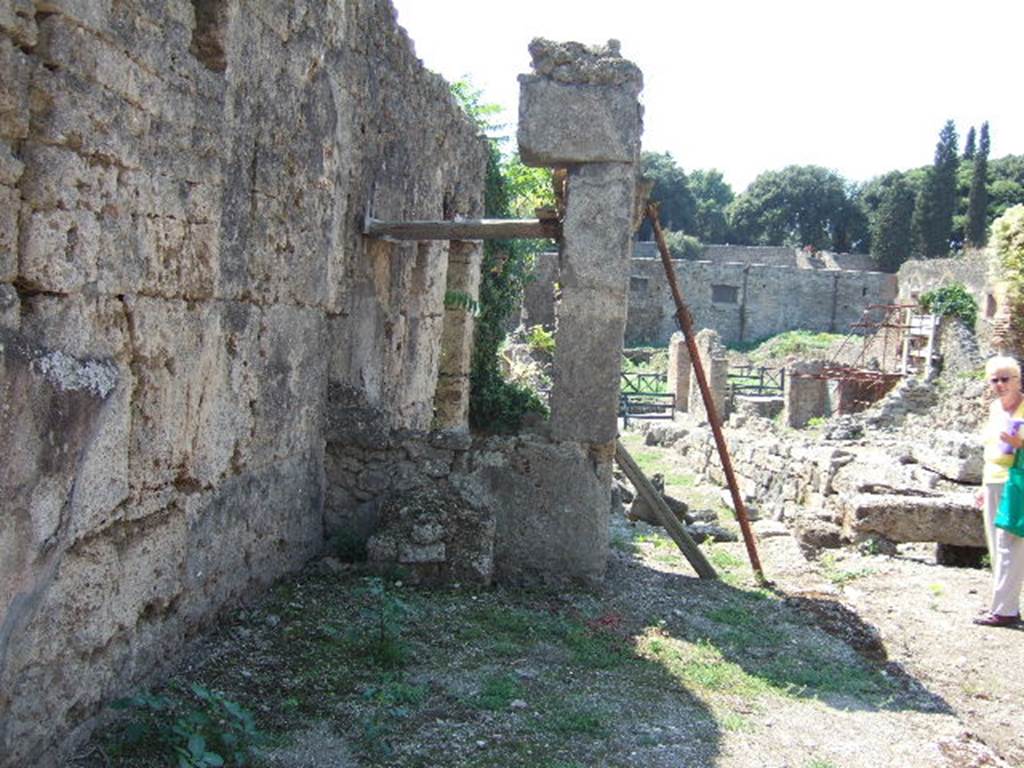 I.5.2 and 1.5.1 Pompeii. September 2005. Before restoration, looking west from near entrance at 1.5.2. Looking towards east side of monumental structure or portico wall, on Vicolo del Conciapelle with Via Stabiana in distance.



 
