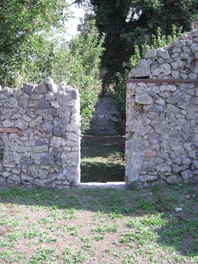 I.5.2 Pompeii. September 2010. Doorway in south wall of peristyle area, leading to large open area. Photo courtesy of Drew Baker.
