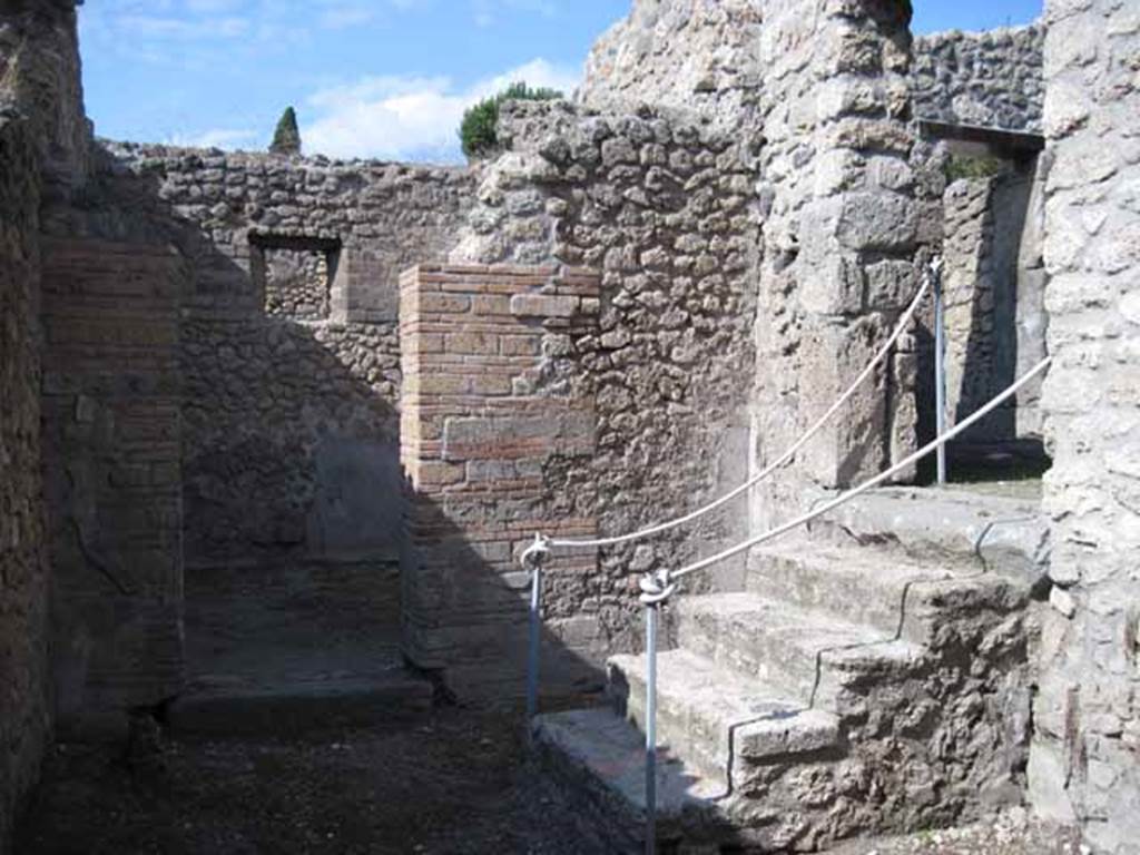 I.5.2 Pompeii. September 2010. Looking north into room with window overlooking Vicolo del Conciapelle, and steps to a back room. Photo courtesy of Drew Baker
