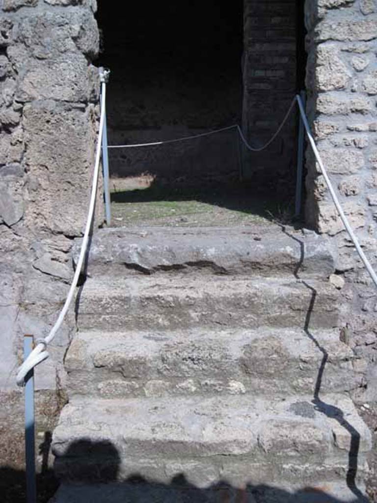 I.5.2 Pompeii. September 2010. Steps leading east towards a back room with fifteen round vats. Photo courtesy of Drew Baker.
