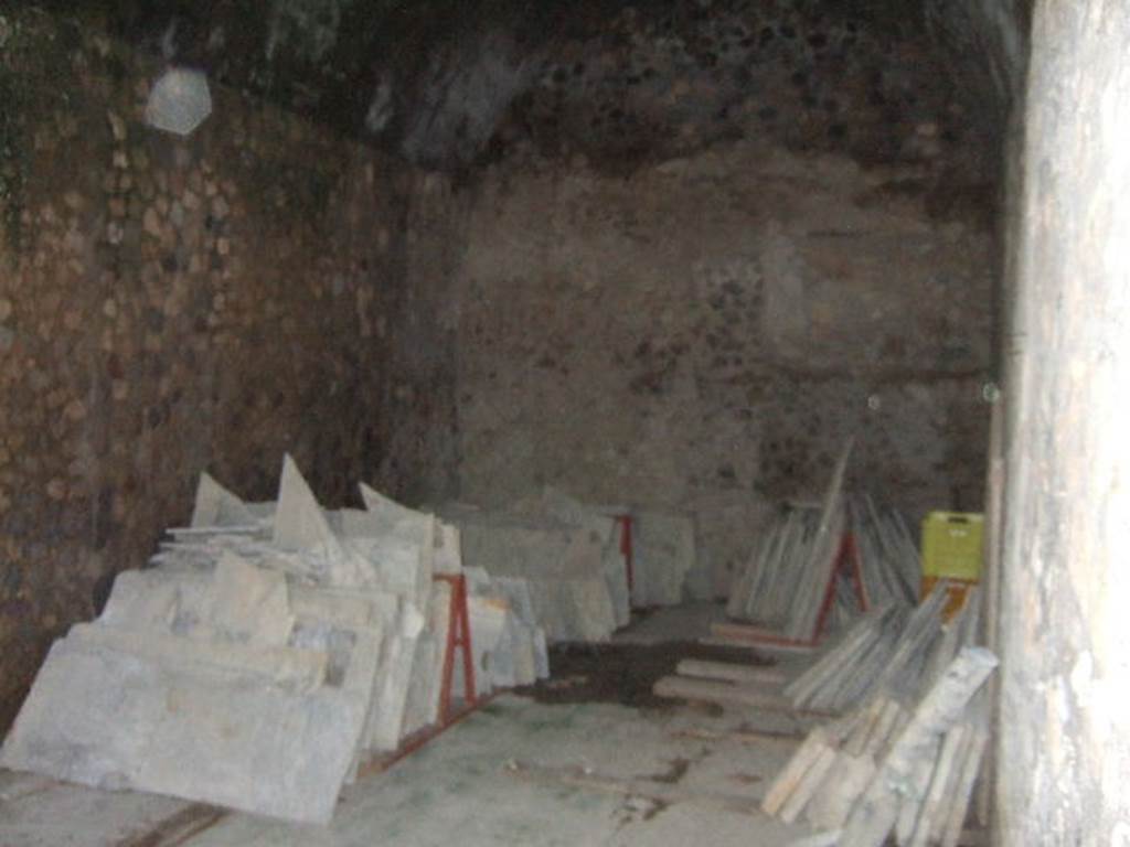 I.6.2 Pompeii. May 2006. Looking north-east across the oecus/triclinium in south-east corner. According to Warscher, the paintings from this room were partially destroyed in the last period of Pompeii. This would have been when the corridor and connecting rooms were transformed into a storehouse or wine cellar. Found on the south wall was a well preserved picture showing a sacrificial table with a basket full of fruit. On the left stood a cock.
The first picture on the north wall showed The Sacred Wedding: the young girl is seated in a two-wheeled cart drawn by two women, led by a dancing Maenad playing the double flute.
See Warscher, T., 1930. Pompei in three hours. Rome (p.142-3). 
